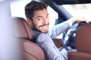 Young business man sitting in new car
